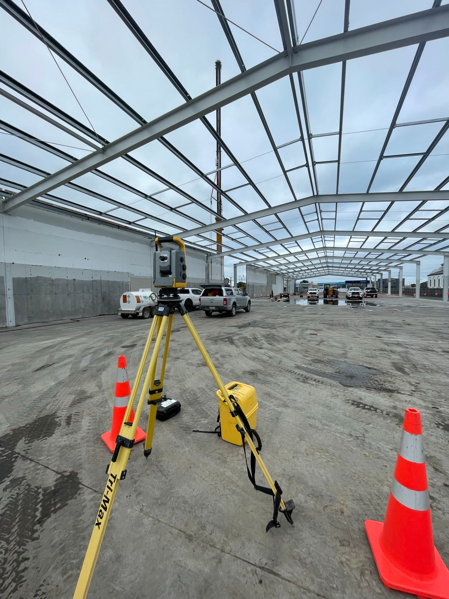 A total station set up inside a commercial building under construction