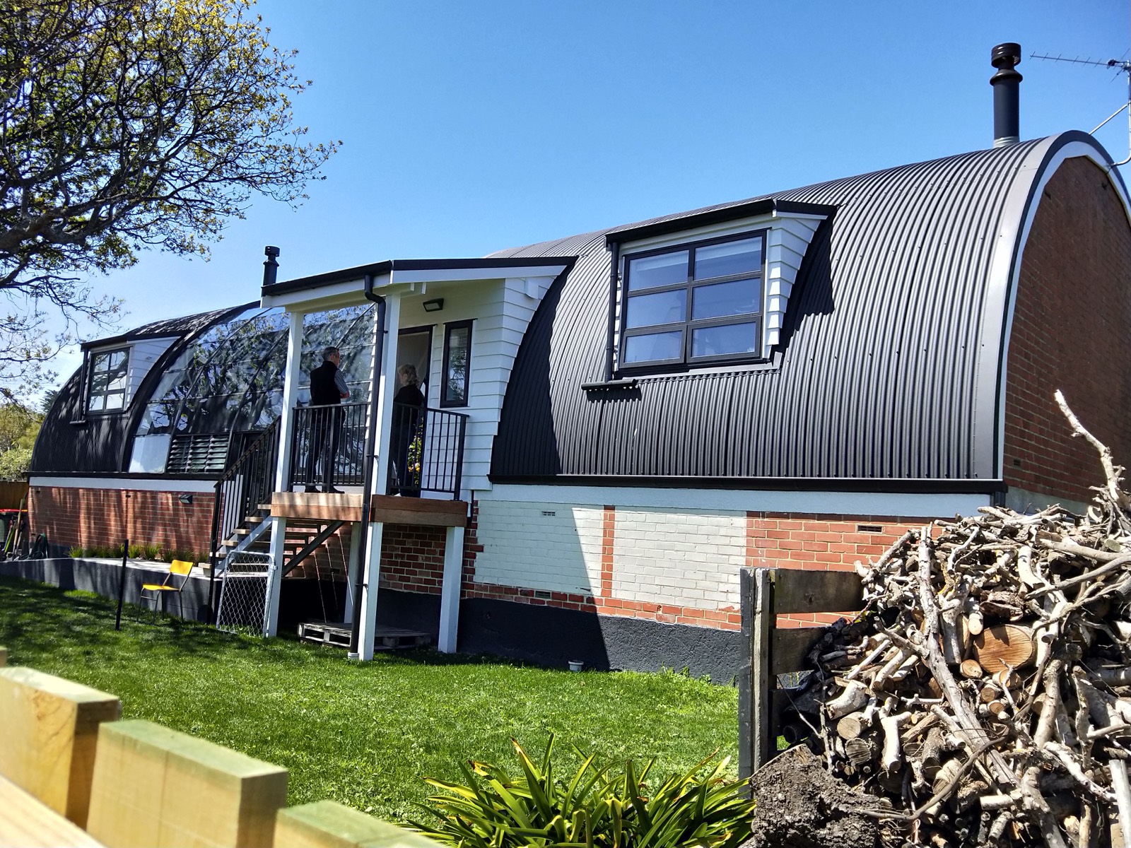 A renovated home with a curved iron roof